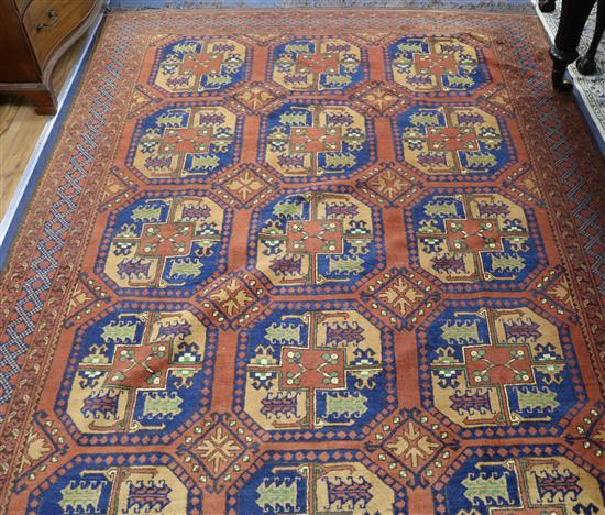 An Afghan hall carpet, field of octagons on a russet ground 288 x 199cm